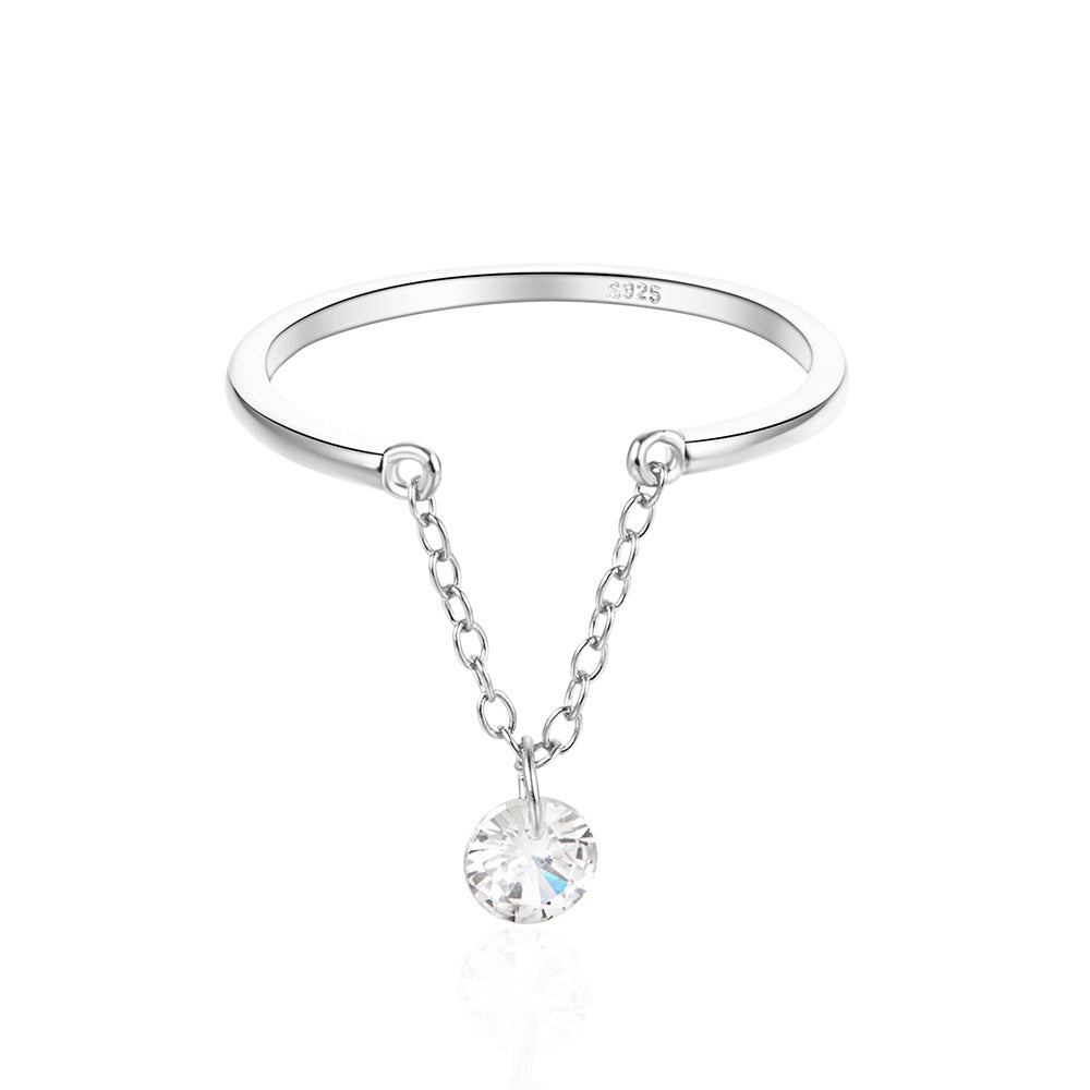 A hand modeling an adjustable open-chain ring with a single solitaire diamond, crafted from polished S925 silver. The minimalist design features a sleek chain link band, styled with both casual denim and a tailored blazer for versatile sophistication.