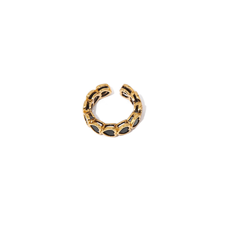 This image displays a hollow heart shaped zircon ring with a minimalist vintage design. The ring features black and white zircon stones and an 18K gold-plated brass structure. It's a perfect accessory for those who enjoy delicate and retro-chic jewelry styles. Ideal for casual and evening wear, it adds a modern touch to any outfit.