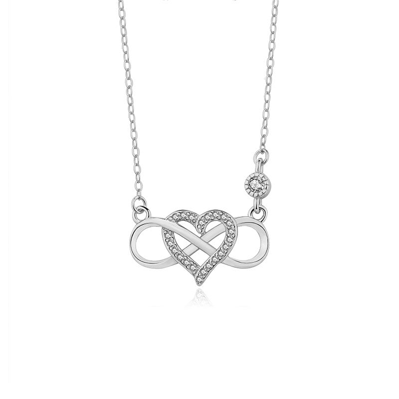 A model wearing a luxe heart-shaped zirconia necklace with a unique Mobius design, crafted from 925 sterling silver. The delicate collarbone chain shines in a polished silver tone, styled with an elegant dress for special occasions or everyday minimalist fashion.