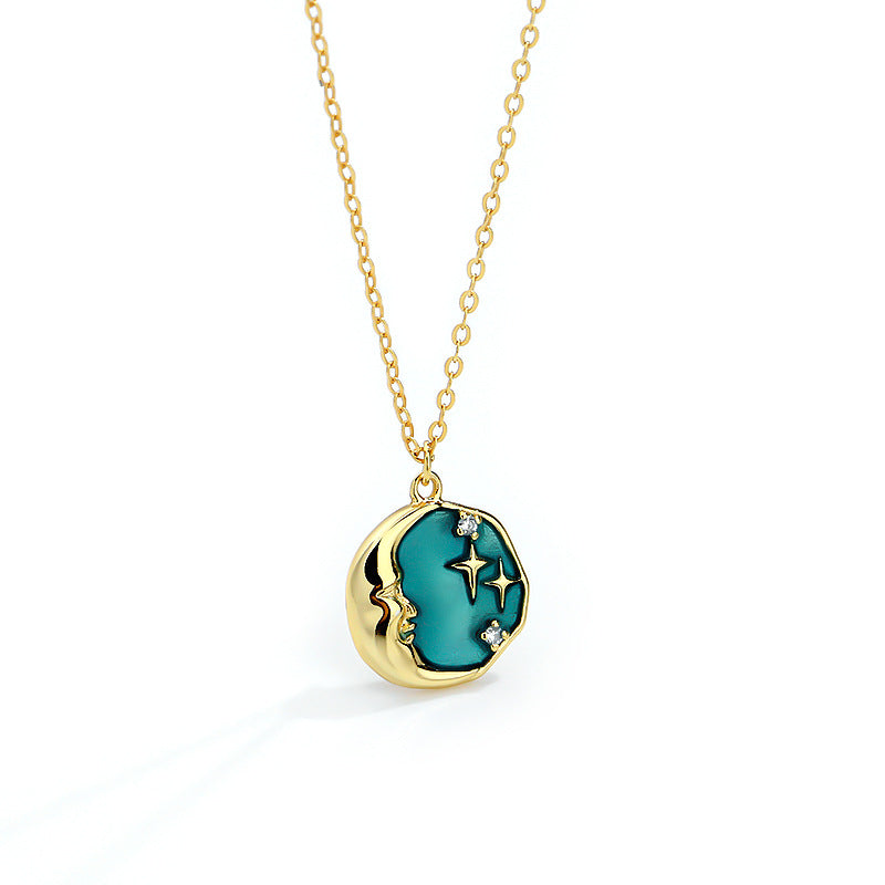 A model wearing a luxe star and moon necklace made of 925 sterling silver, featuring minimalist Nordic design with aqua green accents. The celestial pendant shines in a polished silver tone with subtle hues, styled for everyday elegance or as a unique gift for special occasions.