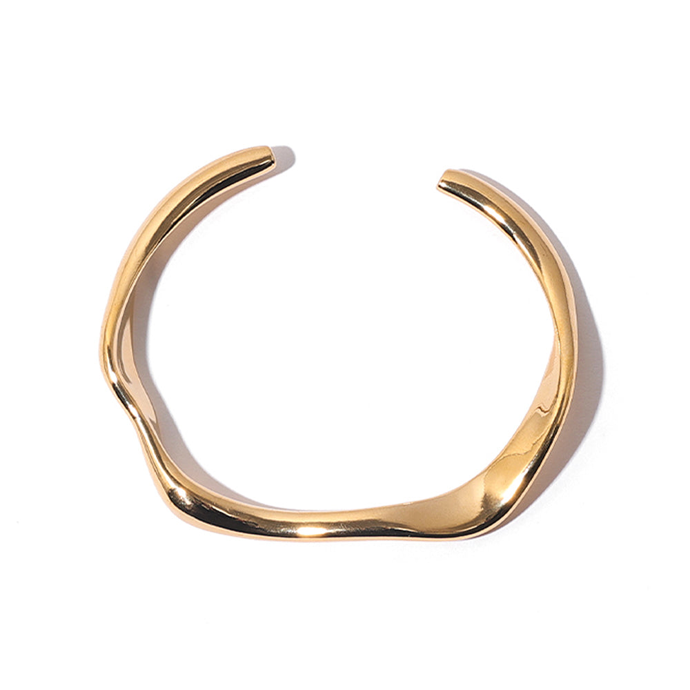 This modern asymmetrical open cuff bracelet from ChicBlingBabe features a smooth, polished finish in a radiant gold-tone. Perfect for daily wear and special occasions, this minimalist statement piece enhances any outfit with its sleek and contemporary design, making it a must-have for fashion lovers.