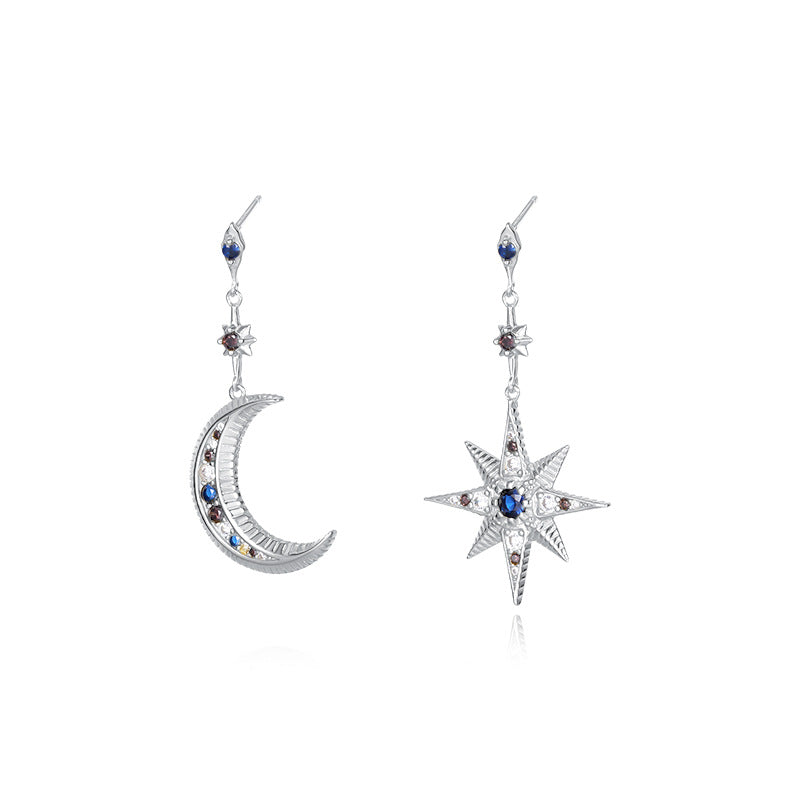 A model wearing asymmetric star and moon zirconia earrings made of 925 sterling silver, featuring colorful gemstones in a minimalist European design. The earrings are styled for casual or formal outfits, perfect as a unique gift for special occasions.