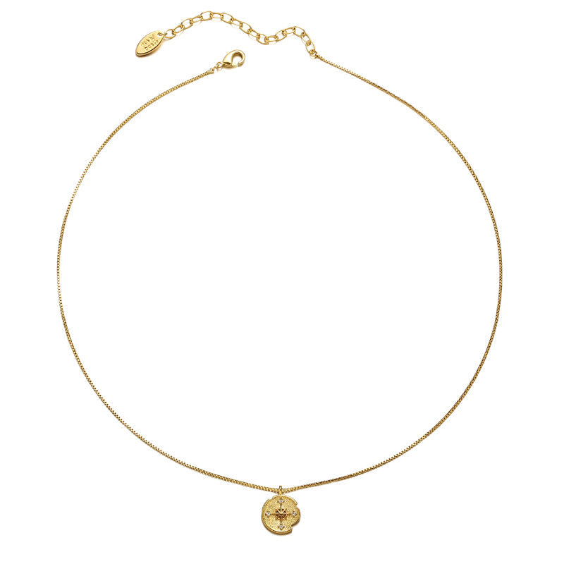 A gold-tone pendant necklace featuring a starburst design adorned with a shimmering zircon stone on a round charm. This celestial-inspired piece complements both casual and formal outfits, making it a perfect minimalist accessory for layering or wearing alone.