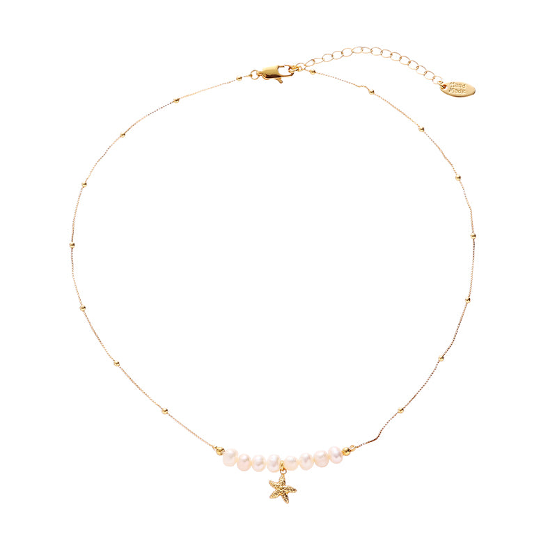 The image shows a ChicBlingBabe necklace featuring a layered design with freshwater pearls, a gold starfish charm, and a mother-of-pearl drop pendant in soft ivory tones, ideal for beach days, tropical vacations, or summer brunch styling.