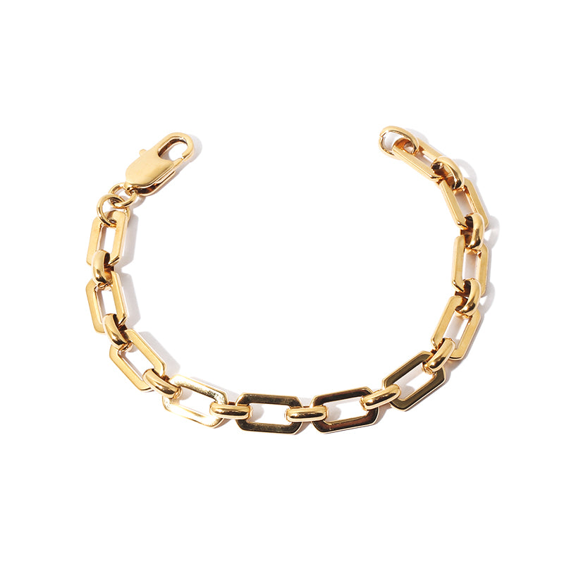 This image features a trendy chunky gold chain bracelet with bold interlocking links, exuding a modern and edgy vibe. The bracelet's thick gold-tone chain makes it a perfect statement piece for casual outfits, evening wear, or layering with other accessories. Its polished finish and substantial design add a touch of luxury and confidence to any look, making it a must-have fashion accessory for trendsetters.