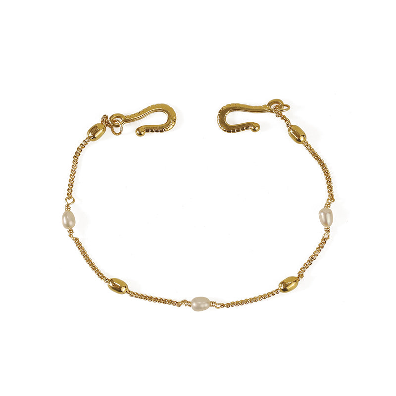The ChicBlingBabe fishhook pearl bracelet features a delicate gold-tone chain with a unique fishhook-inspired design and natural freshwater pearls, making it a perfect accessory for both casual and elegant occasions. The vintage aesthetic and minimalist style add a sophisticated touch to any outfit, ideal for layering with other jewelry pieces.