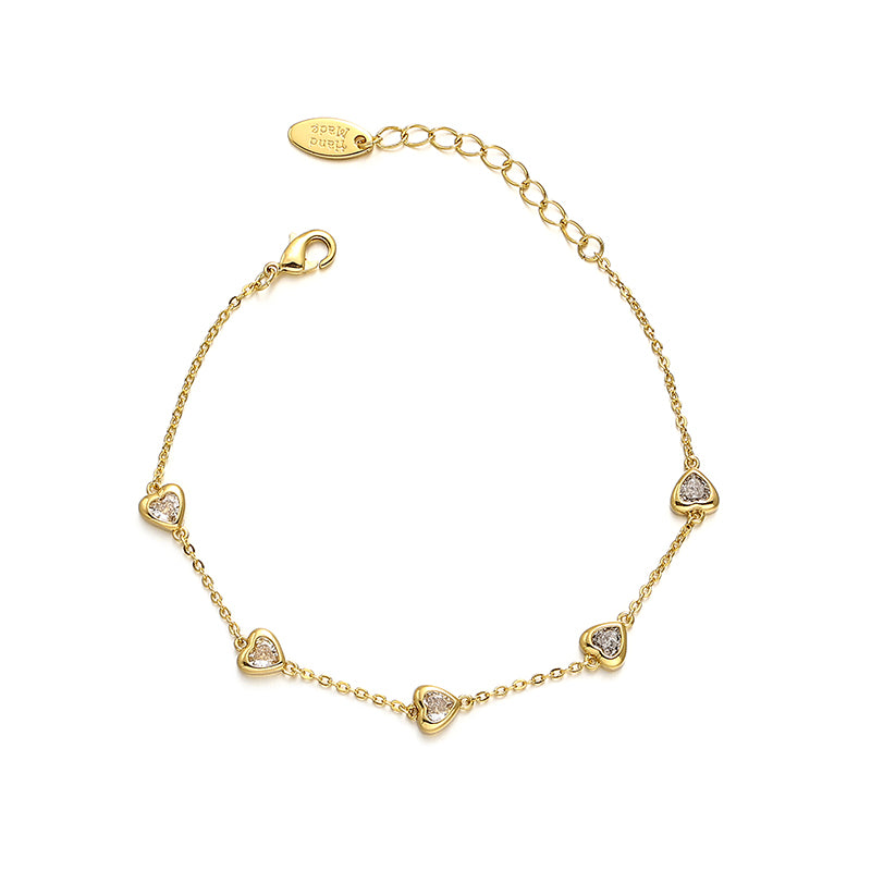 This image showcases a vintage heart zircon bracelet with elegant heart-shaped zircon stones embedded in an 18K gold-plated brass base. The stylish French-inspired design makes it perfect for adding a chic touch to any summer outfit, whether casual or semi-formal. The Chicblingbabe Vintage Heart Zircon Bracelet is a sophisticated accessory that enhances your jewelry collection.