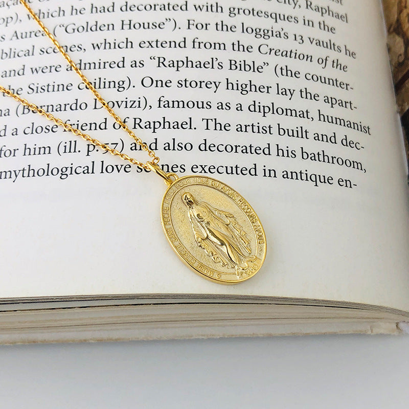 A model wearing a vintage portrait pendant necklace crafted from S925 sterling silver, featuring intricate details in a polished silver tone. The antique-inspired design is styled with a casual outfit for daily wear or as a meaningful gift for art lovers.