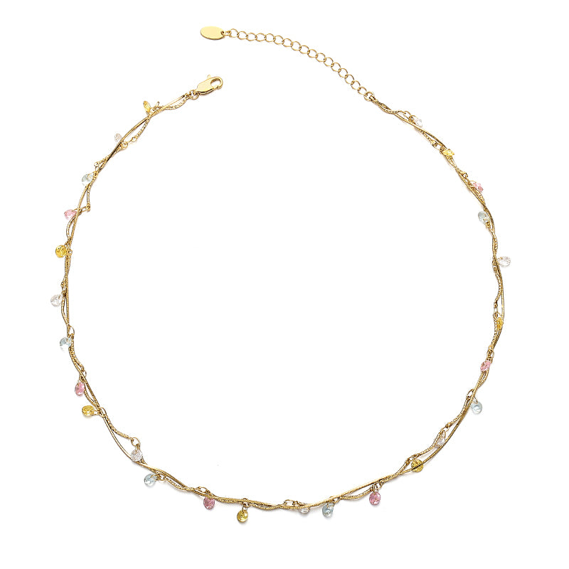 This image displays a luxurious 18K gold-plated brass necklace featuring a spiral design with colorful zircon stones. The necklace has a retro French-inspired style, perfect for casual or semi-formal events. Its vibrant color and elegant design make it a standout accessory for both daytime and evening wear.