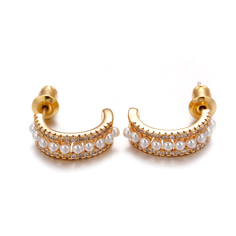 This image features a pair of ChicBlingBabe earrings designed with luminous pearls and dazzling zirconia stones in a delicate drop silhouette, perfect for both everyday elegance and stylish party outfits, glowing in soft champagne tones under natural light.